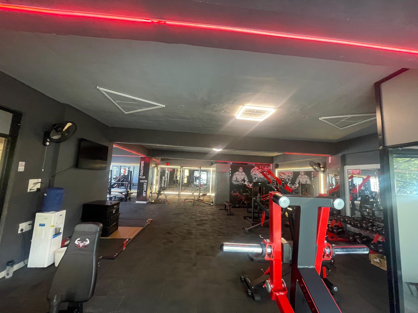 BurnZone Malleshwaram training floor with red LED lighting and strength equipment