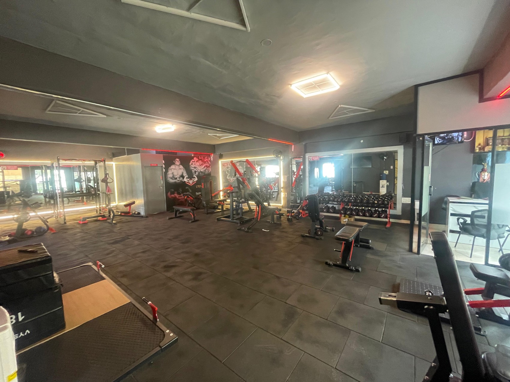 BurnZone Malleshwaram training floor with mirrors and dumbbell rack